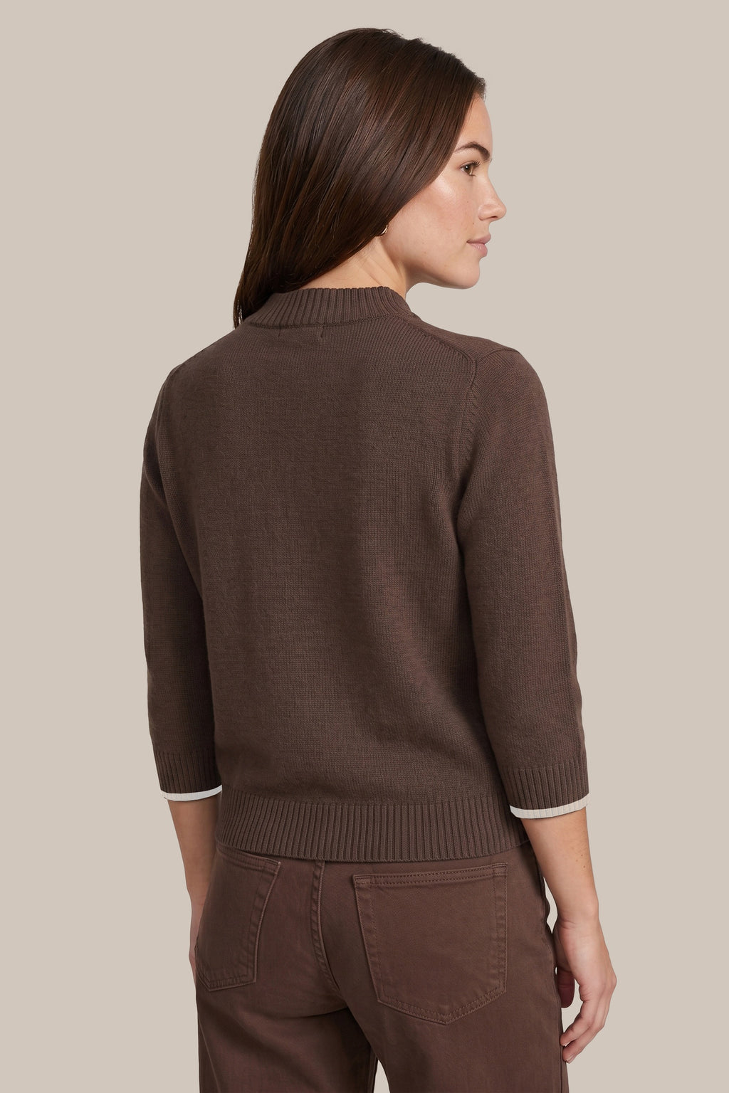 “CS the Label dark chocolate mock-neck sweater on a woman, front view with 3/4 sleeves and cream cuff trim”