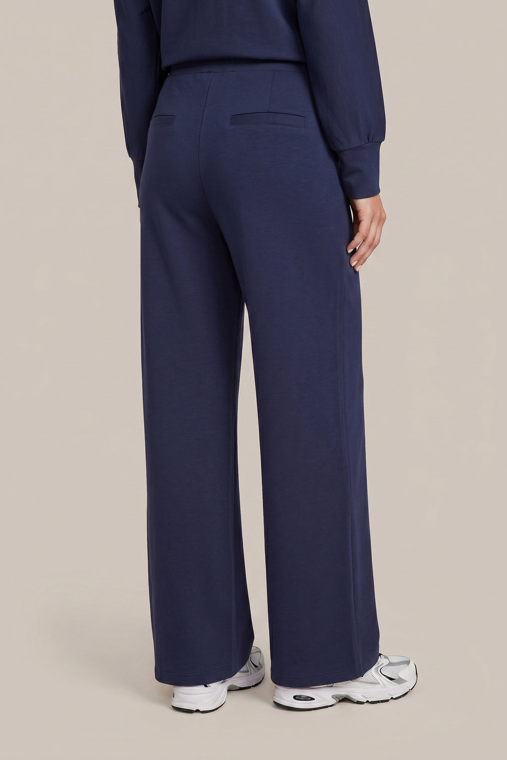 CS the Label navy leisure pants, close-up of elasticized drawstring waist, front pockets, and metal tips”