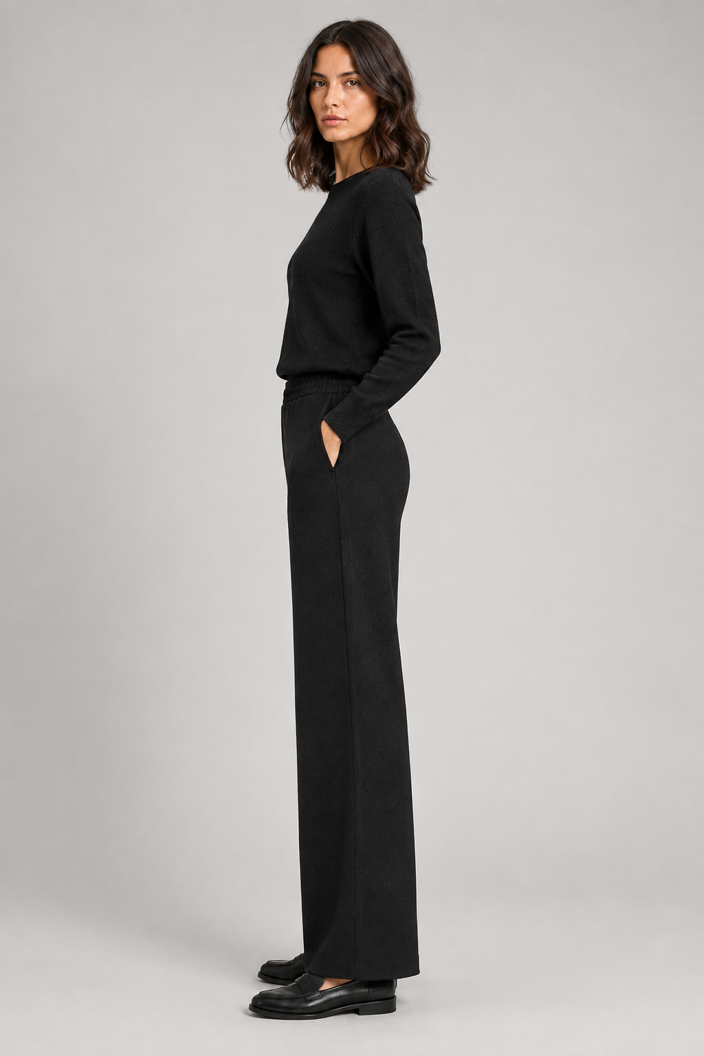 Point Zero black wide-leg ponte pant front view on a woman, styled with a black long-sleeve knit sweater
