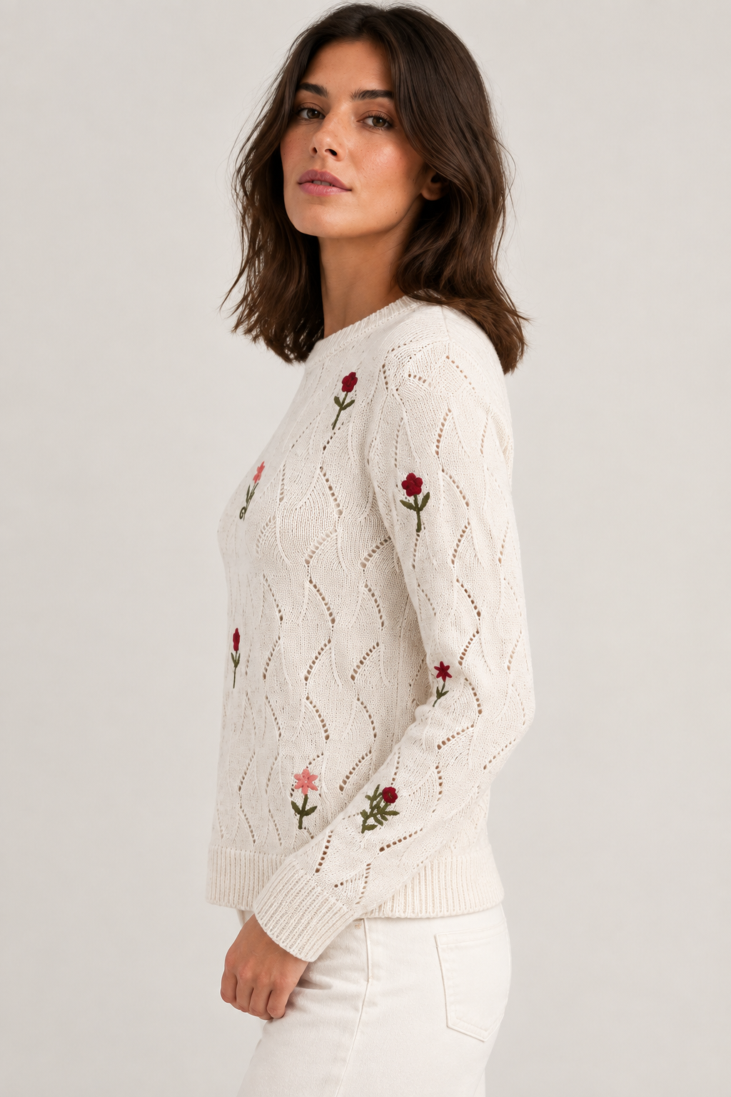 Point Zero cream pointelle knit sweater front view on a woman, showing scattered floral embroidery and crew neckline