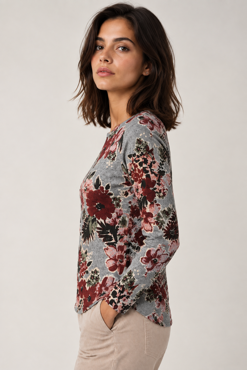 Point Zero grey heathered top front view on a woman, showing the burgundy and pink all-over floral print and crew neckline