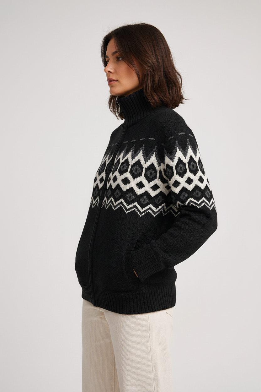 Point Zero black zip-up sweater jacket on a woman, front view with white geometric knit pattern, ribbed stand collar, and front pockets