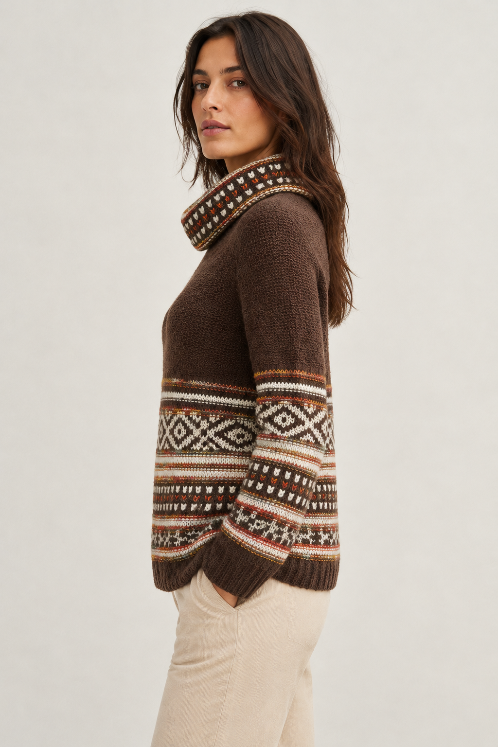 Point Zero brown jacquard cowl neck sweater with cream geometric bands, ribbed trim and relaxed fit, styled with cream trousers.
