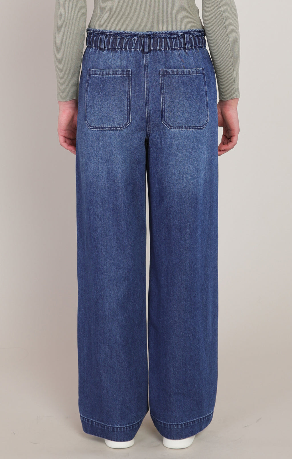 Dex medium wash wide leg denim pant front view, showing the elasticized drawstring paperbag waist and front patch pockets