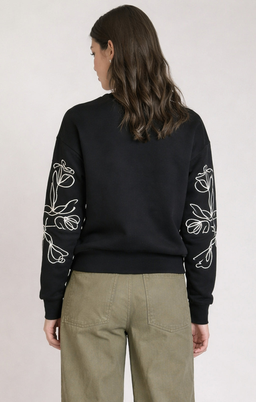 Dex black floral embroidered sweatshirt, front view showing crew neck and abstract chest embroidery