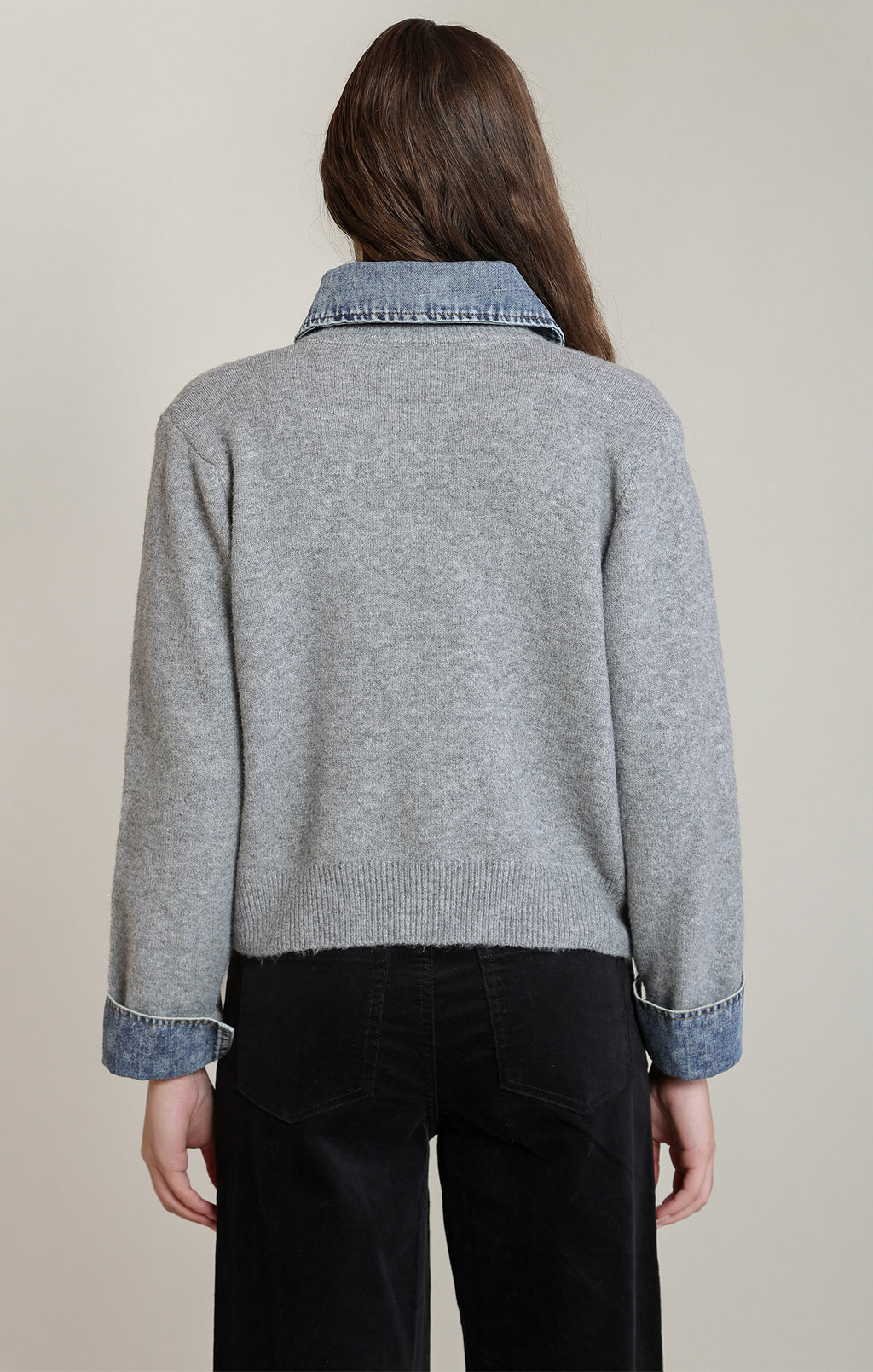 Dex heather grey button-front sweater front view with denim collar and cuff trim and silver buttons, styled with black pants