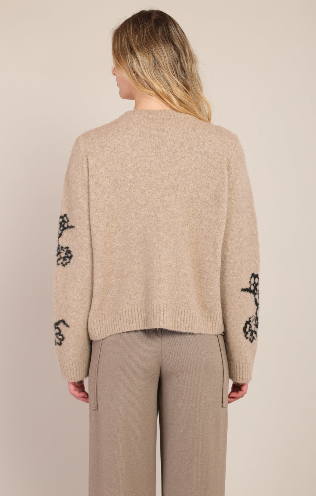 Room 34 taupe floral print sweater, front view showing black outlined flowers and ribbed trim