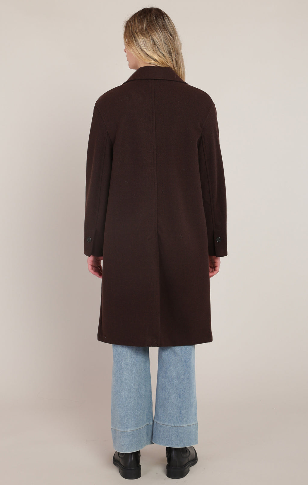  Room 34 dark brown long coat with notched collar, front buttons and light-wash jeans