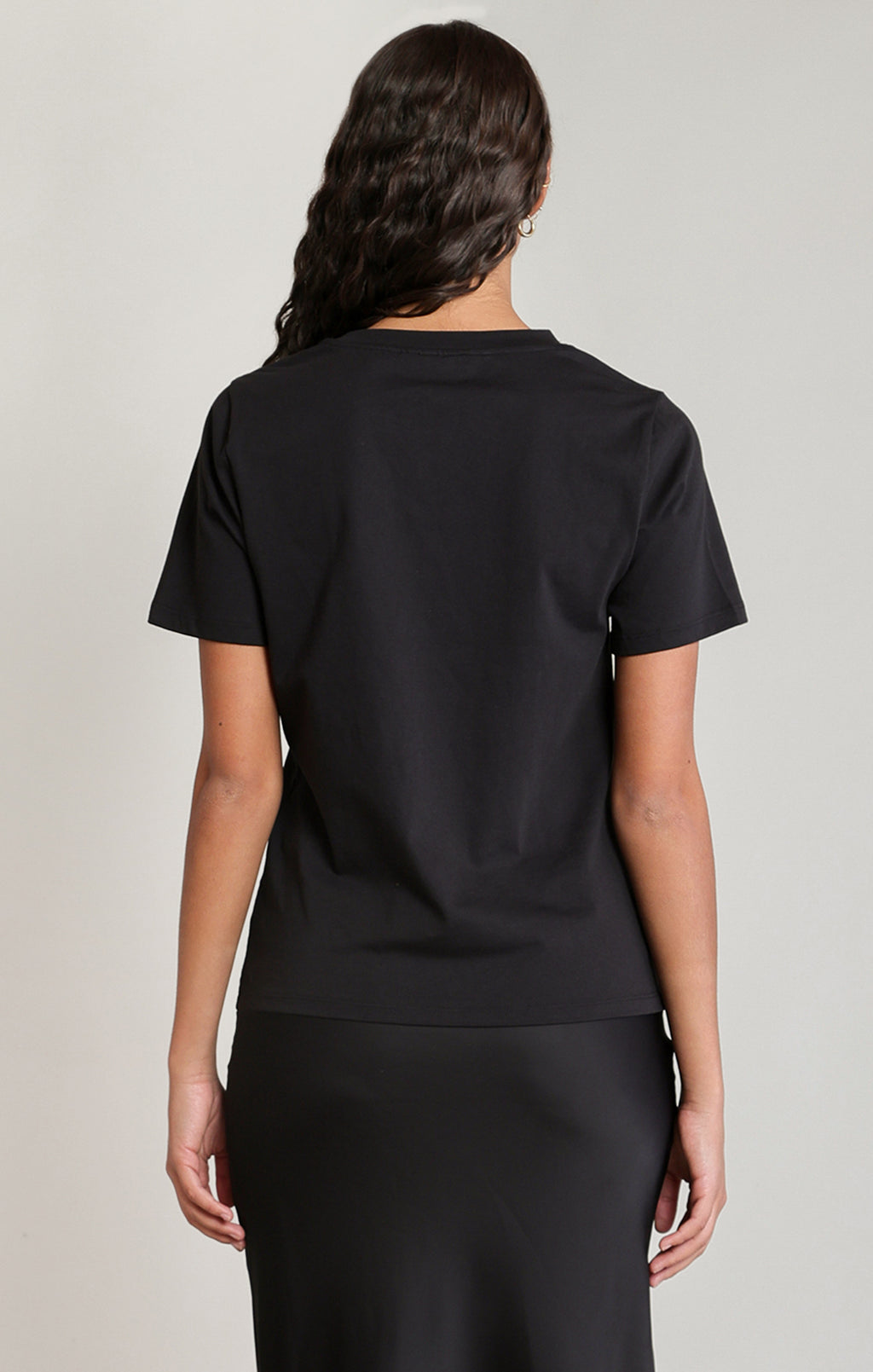  Black Dex crew neck T-shirt with short sleeves, a relaxed fit and scattered crystal bow embellishments across the front, styled with a black skirt